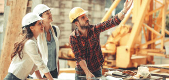 Two female inspectors and architects discuss with head engineer